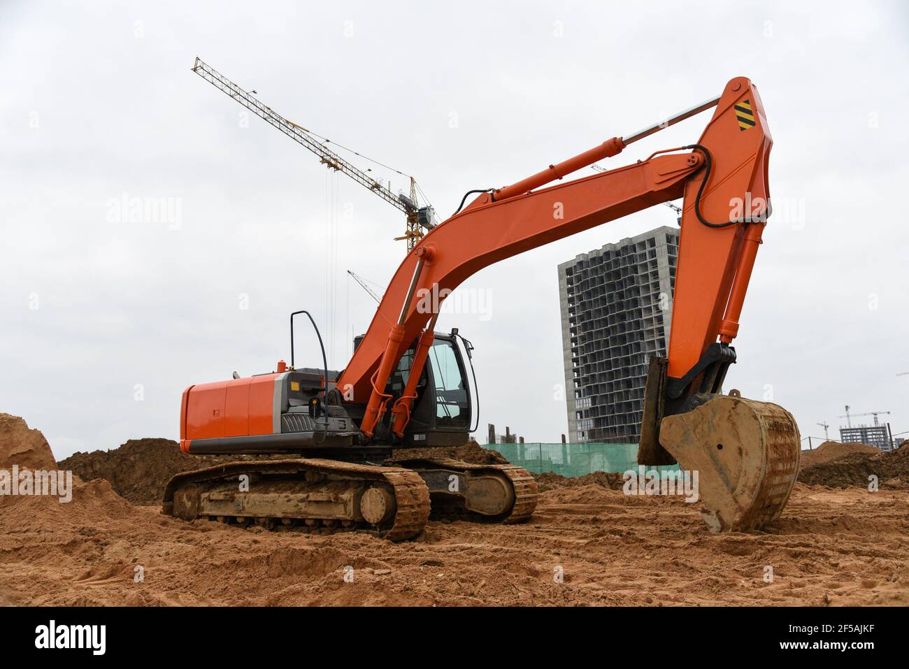 Large Machines In Action Excavator during excavation at construction site. Backhoe on Earthworks ...