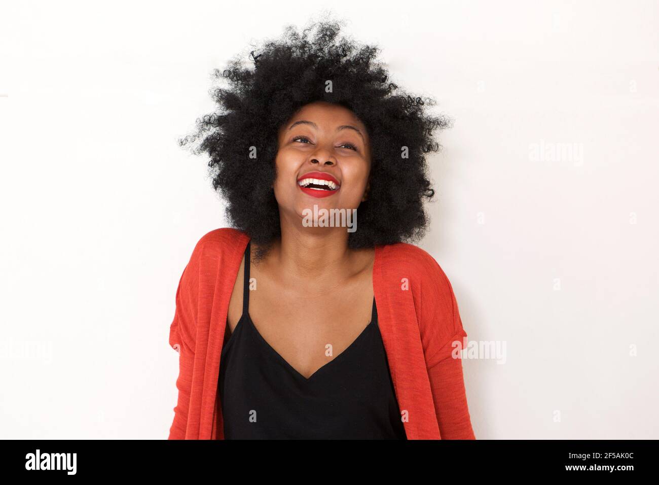 Close up portrait of young african woman laughing by white wall Stock ...