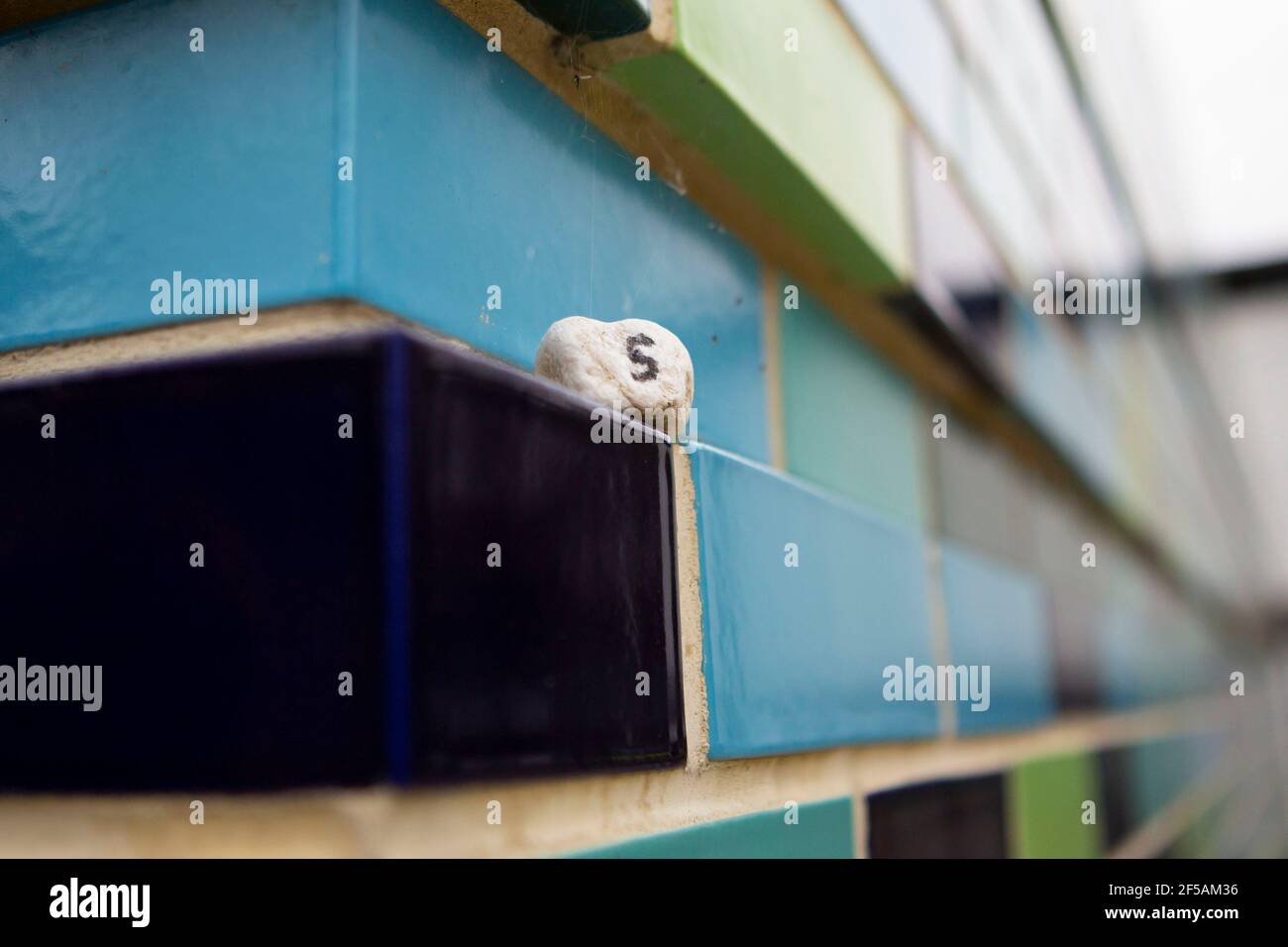 blue ceramic wall tiles with tiny number '5' Stock Photo