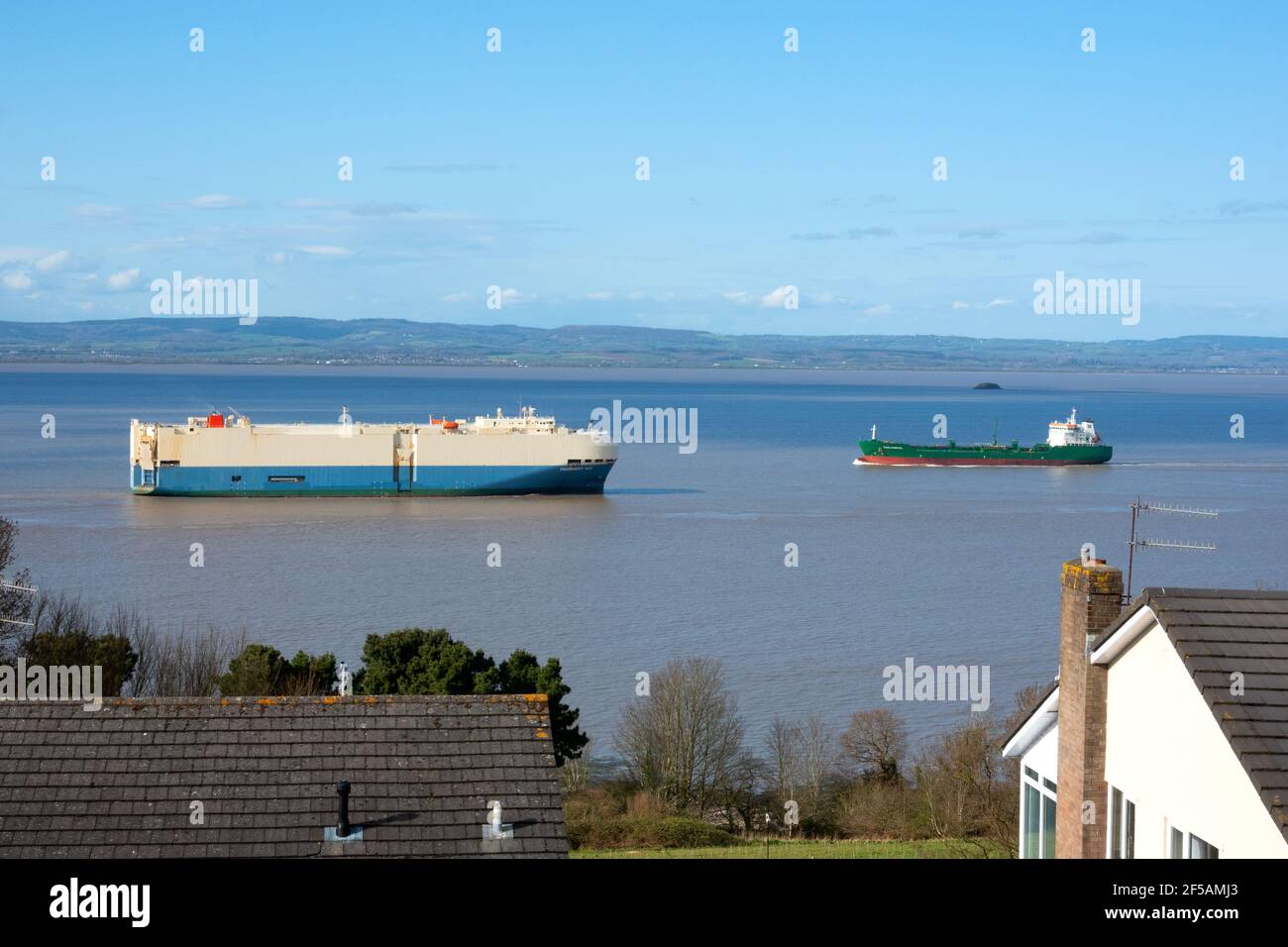 Two ships passing in the Severn estuary off Portishead, UK as the estuary reaches high tide. The ships are using The Royal Portbury dock Stock Photo