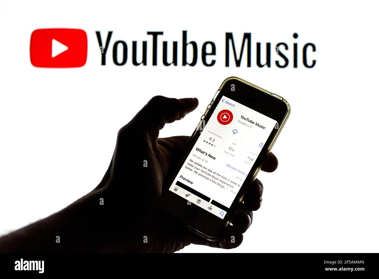 In this photo illustration the YouTube Music app in App Store seen  displayed on a smartphone screen and a YouTube Music logo in the background  Stock Photo - Alamy