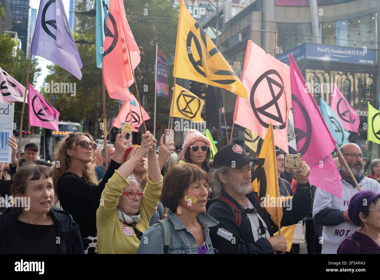 Melbourne, Australia. 25th March 2021. Extinction Rebellion supporters  listen to a talk given on Bourke Street as part of a protest against Rupert  Murdoch's suppression of the issue of climate change in