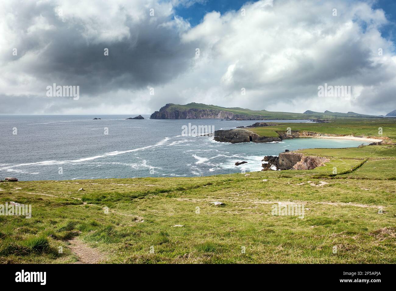 Dingle Peninsula Bay of Ireland with farm pastures and mountains in background Stock Photo