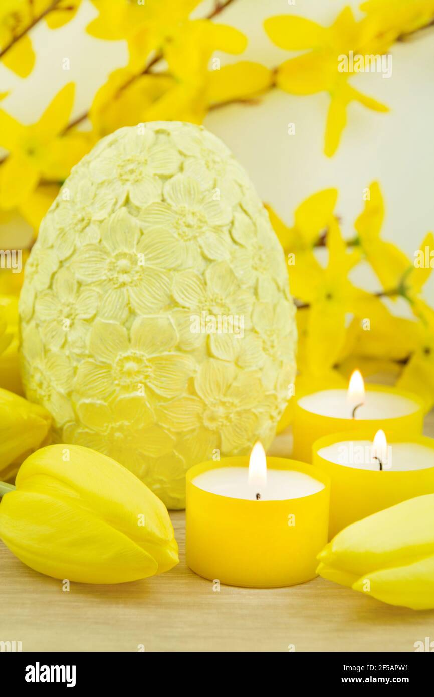 Yellow Easter egg and tulips on wooden background Stock Photo