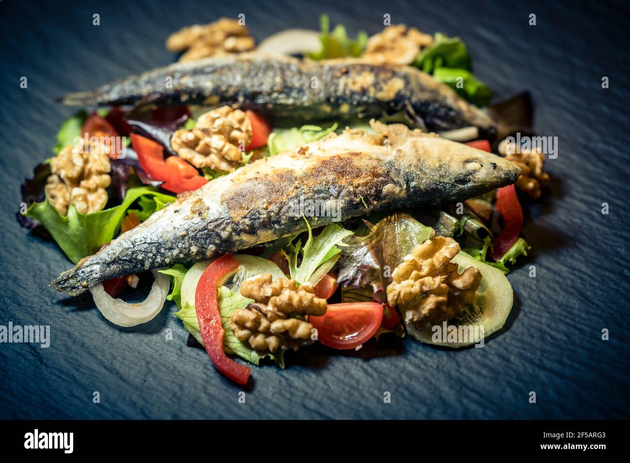 Fried Sardines with green salad and walnuts Stock Photo Alamy