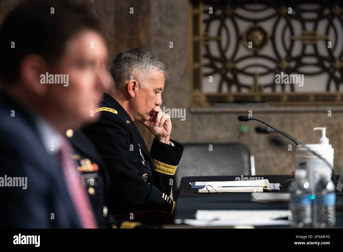 Gen. Paul M. Nakasone, Director of United States National Security Agency, listens during a hearing on the “United States Special Operations Command and United States Cyber Command” with the Senate Armed Services Committee on Capitol Hill in Washington DC on March 25th, 2021.Credit: Anna Moneymaker / Pool via CNP | usage worldwide Stock Photo