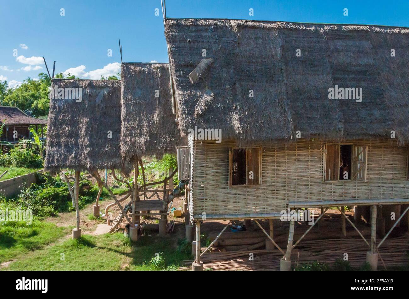 Wooden house in traditional pile construction, the roof is covered with