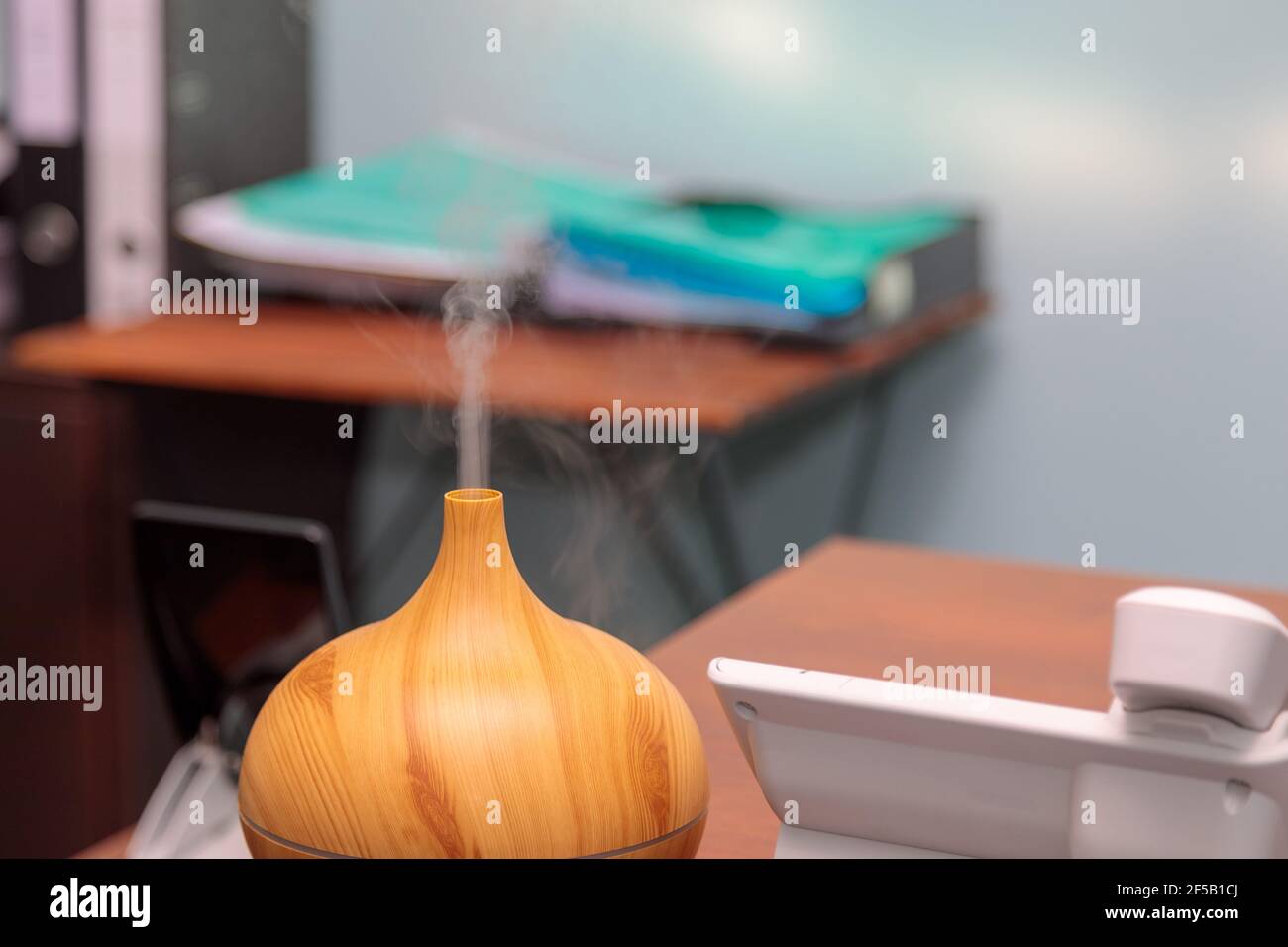 Using an electric humidifier on the desk in the office. Steam flows