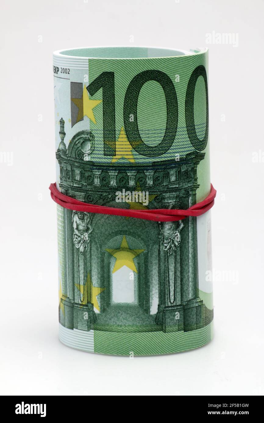 Closeup of a roll of one hundred Euro banknotes isolated on white ...