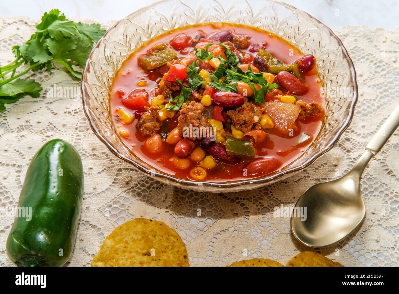 Chorizo sausage chili con carne dinner with corn tortilla chips Stock