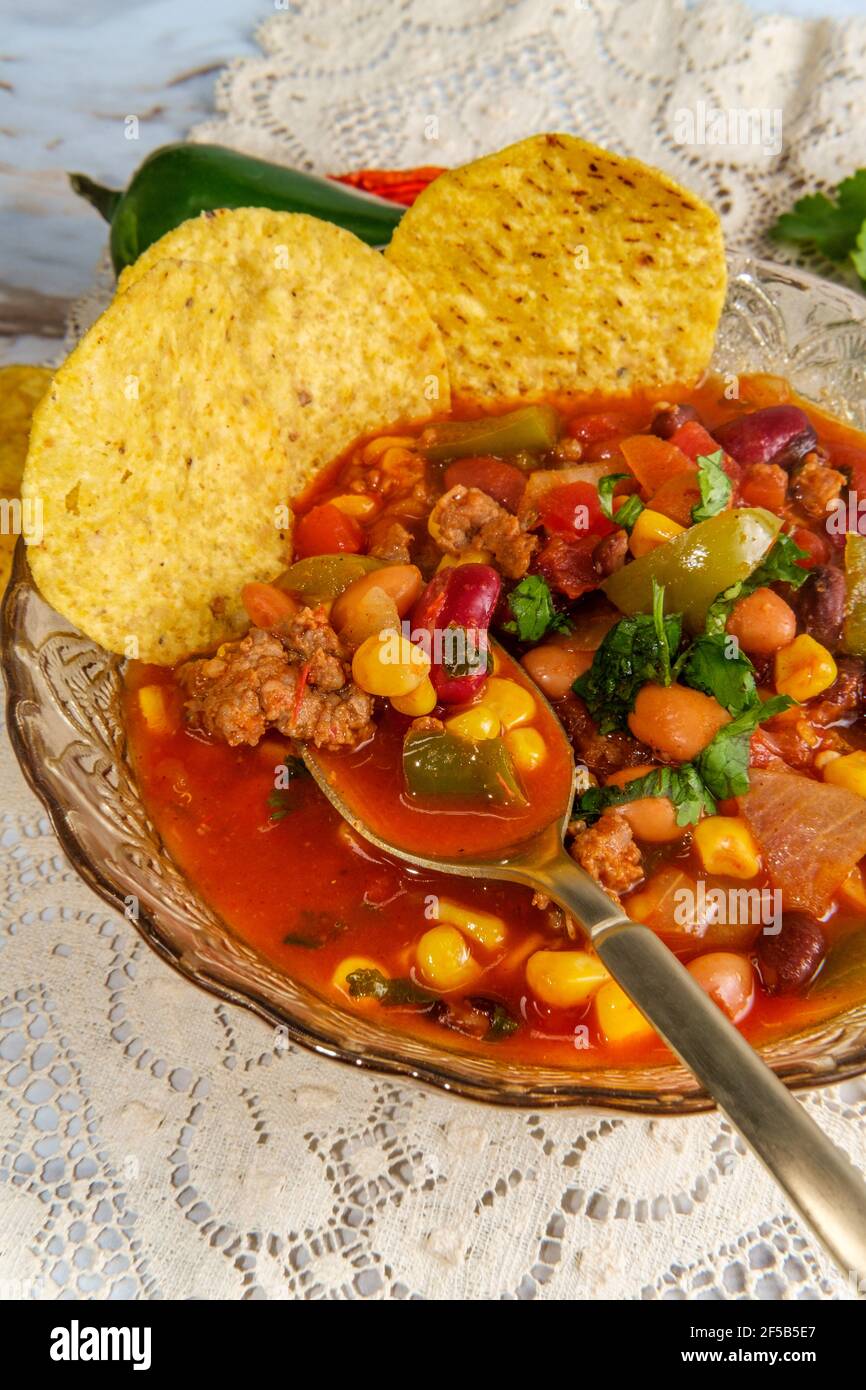 Chorizo sausage chili con carne dinner with corn tortilla chips Stock Photo Alamy