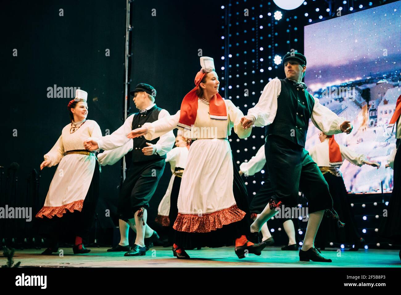 Tallinn, Estonia. Dancers In National Suits Performing Folk Dances During Traditional Celebration Of Christmas Holidays. Stock Photo