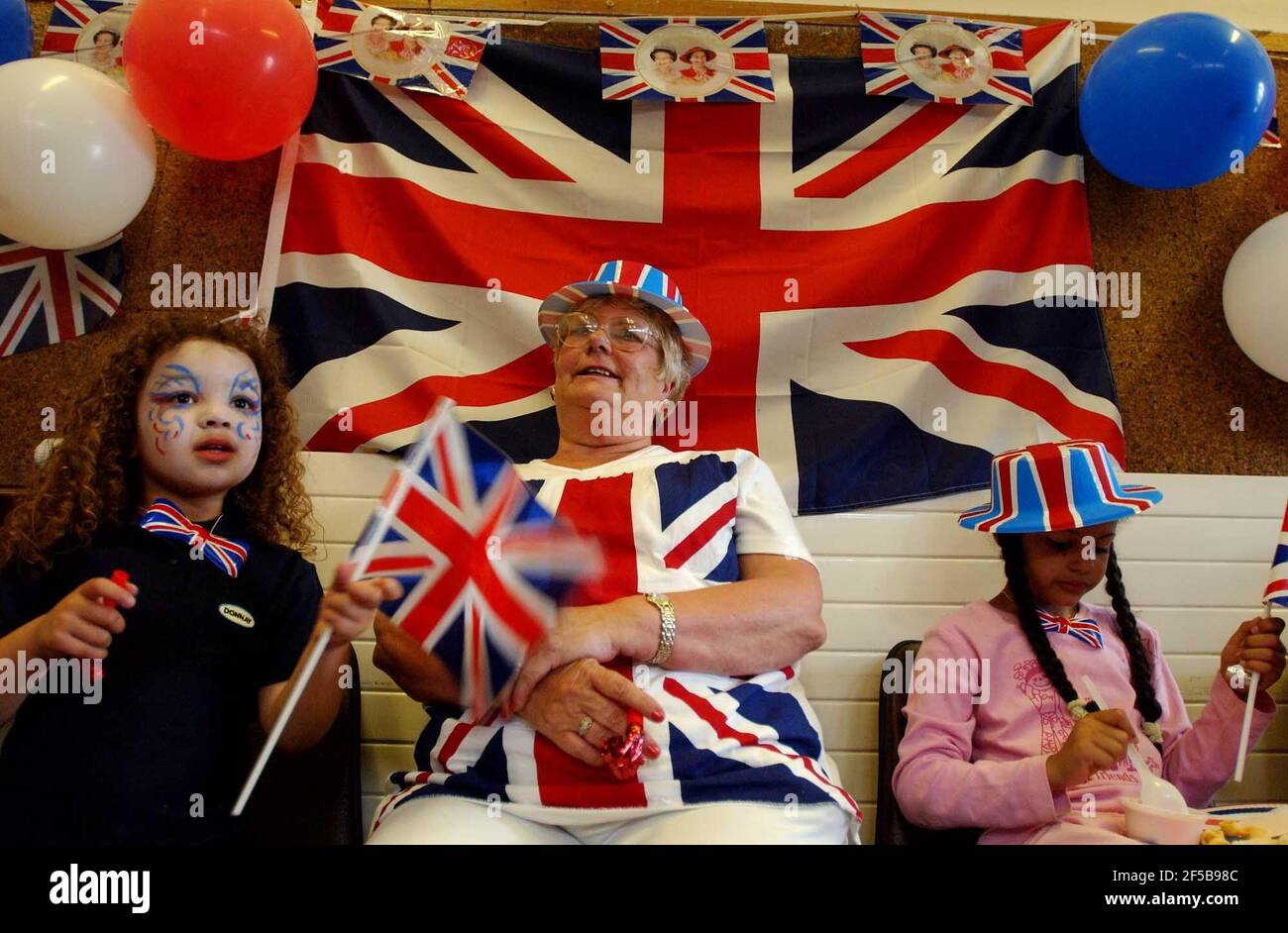 A helper at the Chandos Centre in Stratford at the end of a busy day celebrating the Queen's Golden Jubilee.3 June 2002 photo Andy Paradise Stock Photo
