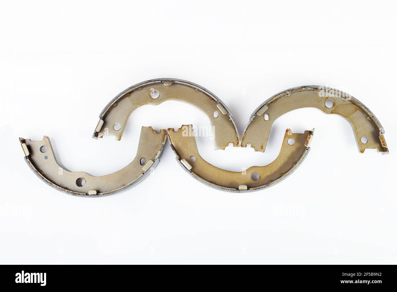 kit of four drum brake shoes with asbestos alloy on steel car spare parts pads isolated on white