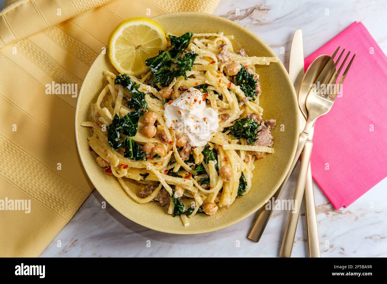Linguine pasta with Italian sausage chickpeas and kale in a creamy
