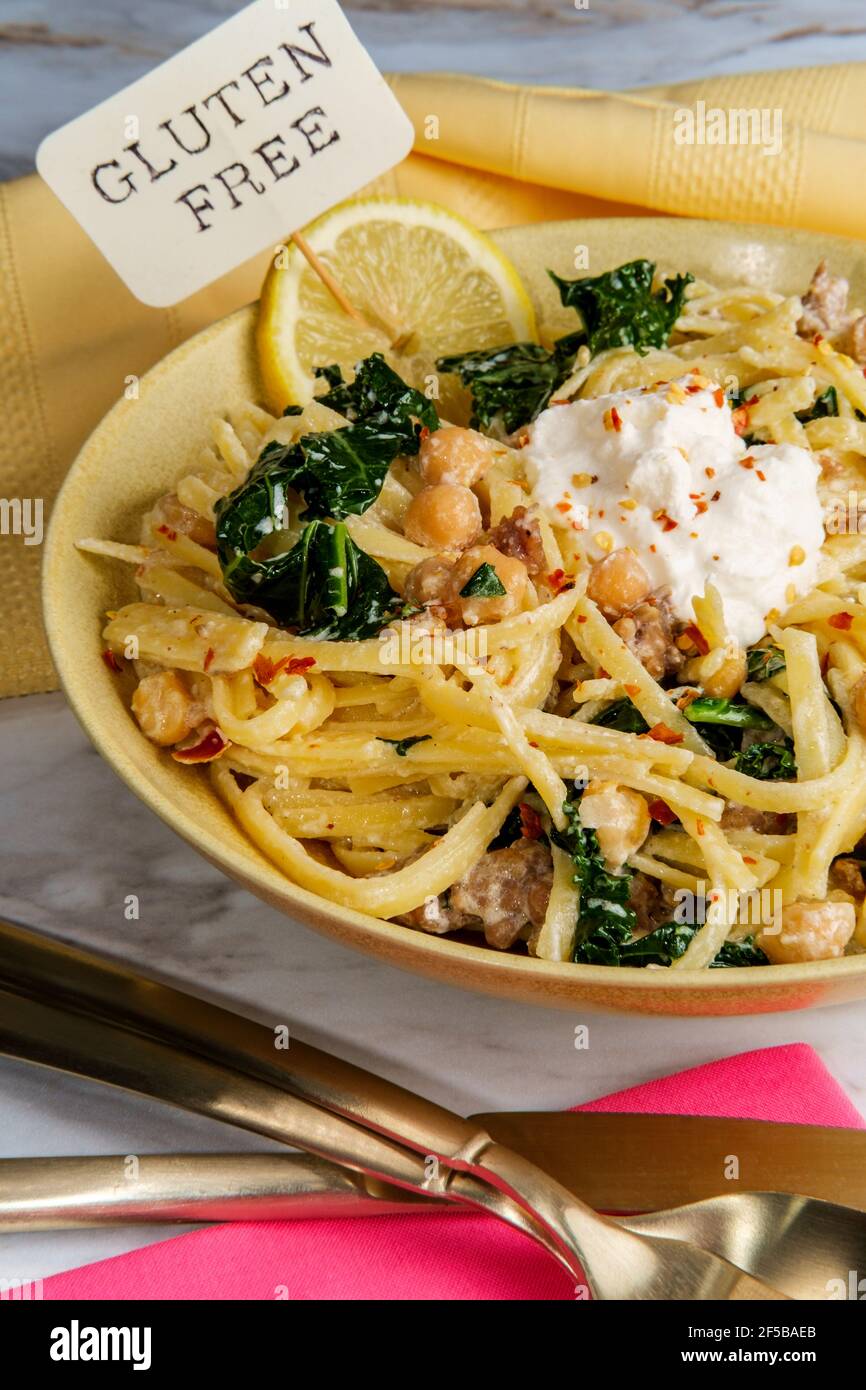 Linguine pasta with Italian sausage chickpeas and kale in a creamy