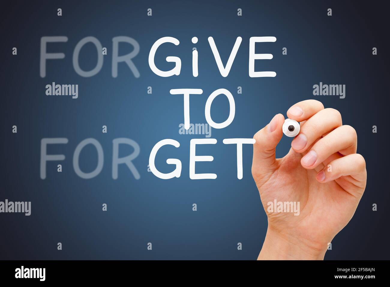 Hand writing with marker Forgive to Forget, Give to Get forgiveness concept. Stock Photo