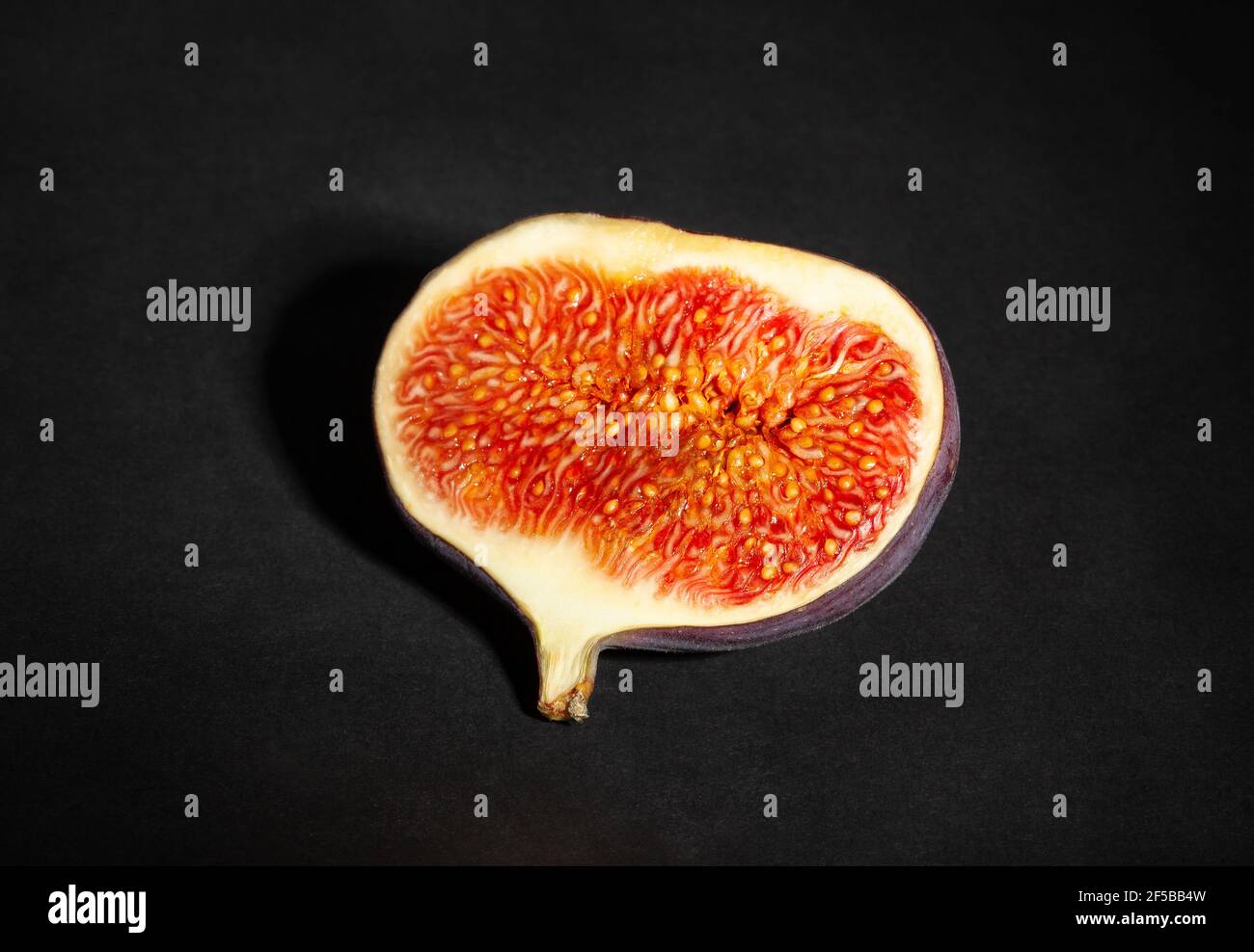 sliced figs on black background Stock Photo