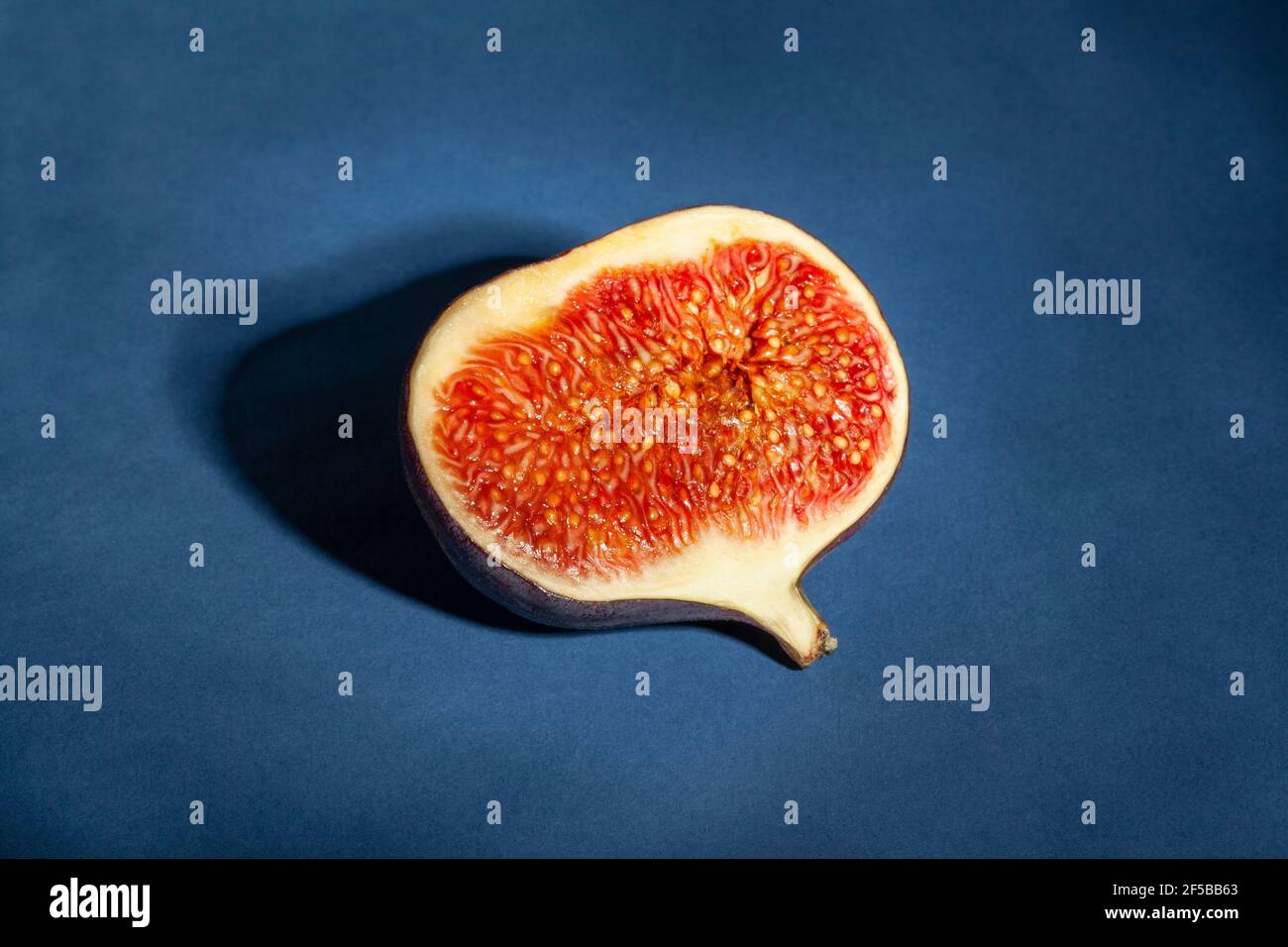 sliced figs on blue background Stock Photo