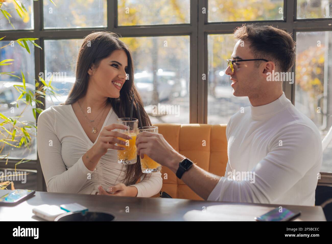 Friends socializing, having fun, and laughing drinking coffee in