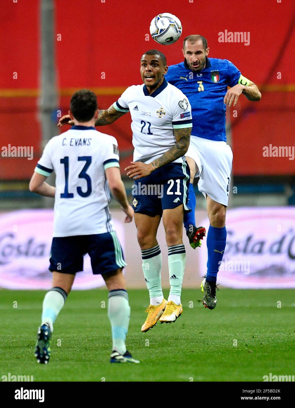 Northern Ireland's Josh Magennis (centre) and Italy's Giorgio Chiellini battle for the ball during the FIFA 2022 World Cup qualifying group C match at Stadio Ennio Tardini, Parma. Picture date: Thursday March 25, 2021. Stock Photo