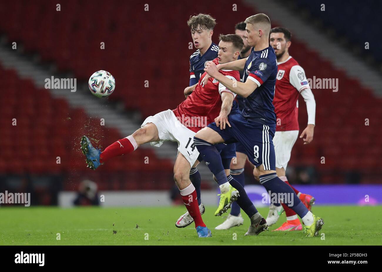 Austria's Sasa Kalajdzic (left) is held back by Scotland's Scott ...