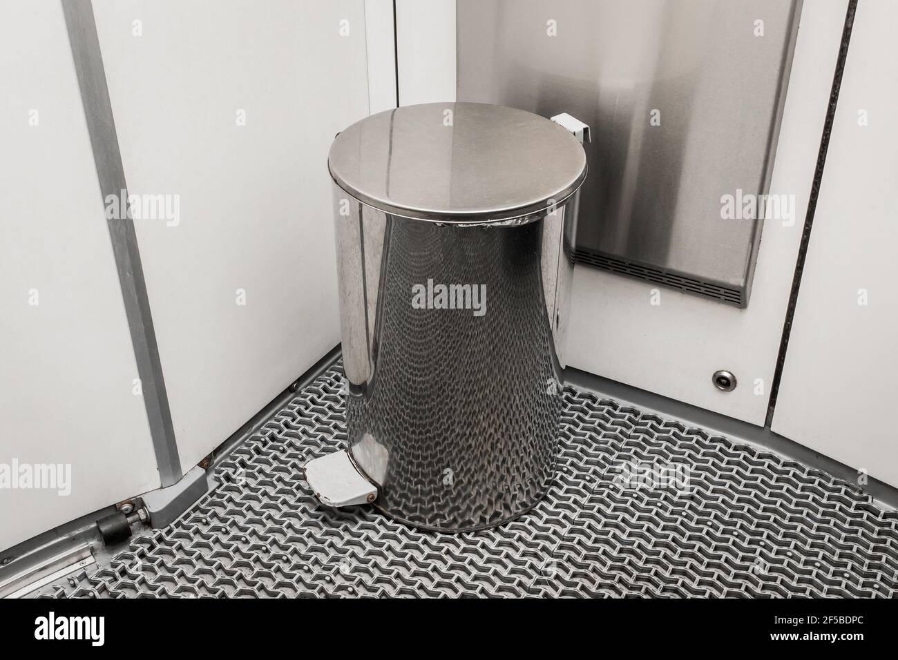 Metal trash can in a modern toilet in an electric train. Stock Photo