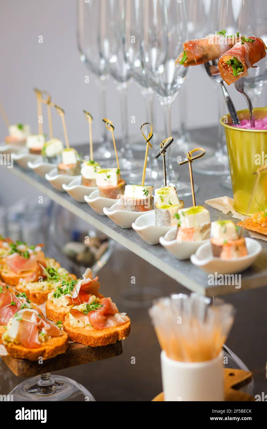 Catering service. Table with snacks food at event Stock Photo - Alamy