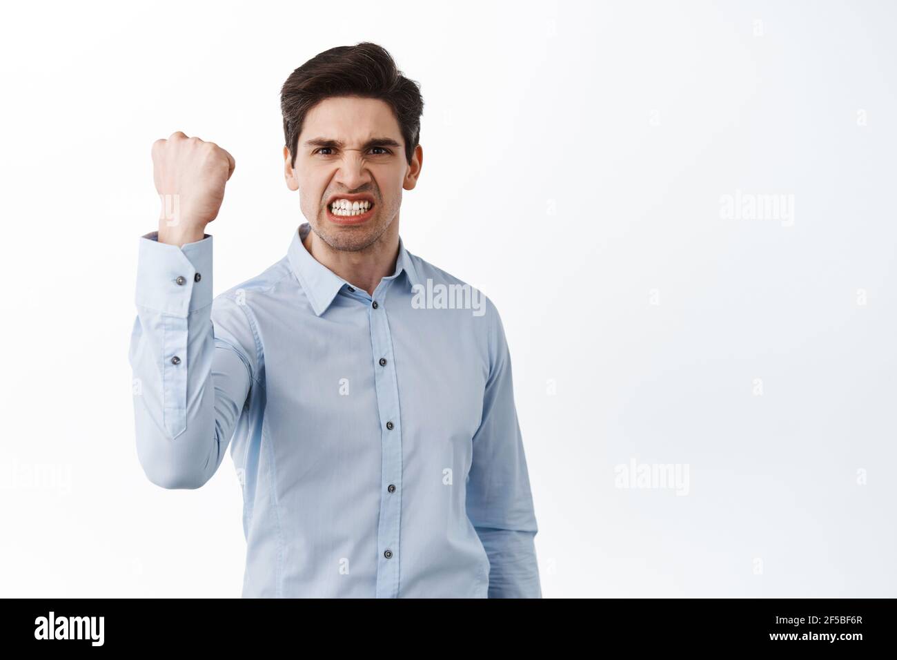 Angry office worker shaking fist in threaten, look outraged and pissed ...