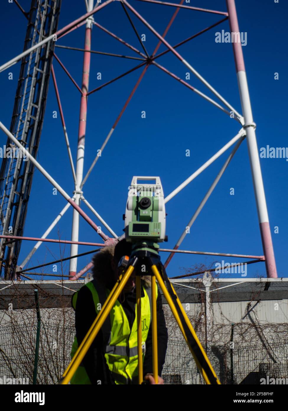 surveying near a cell tower using a total station Stock Photo