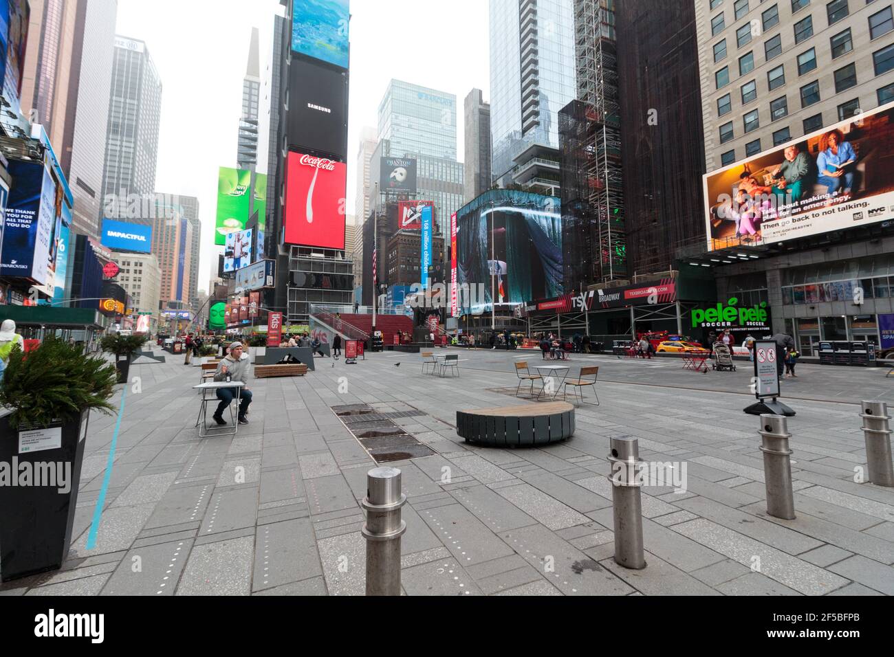 a nearly empty Times Square, New York on a foggy day, tourists and workers are mostly absent during the coronavirus or covid-19 pandemic Stock Photo