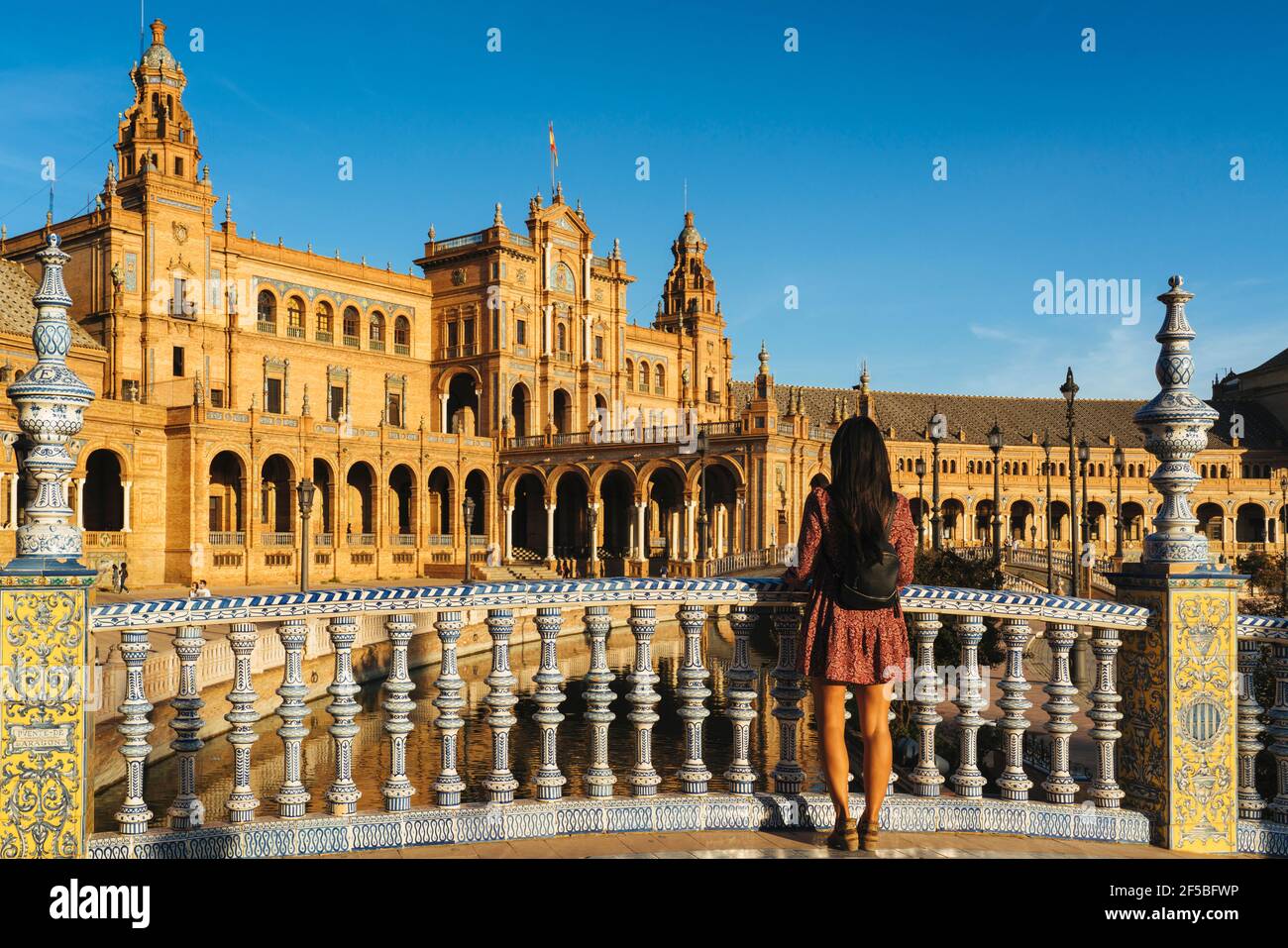 Woman tourist looking views in the bridge of Spain Square in Seville, Spain Stock Photo
