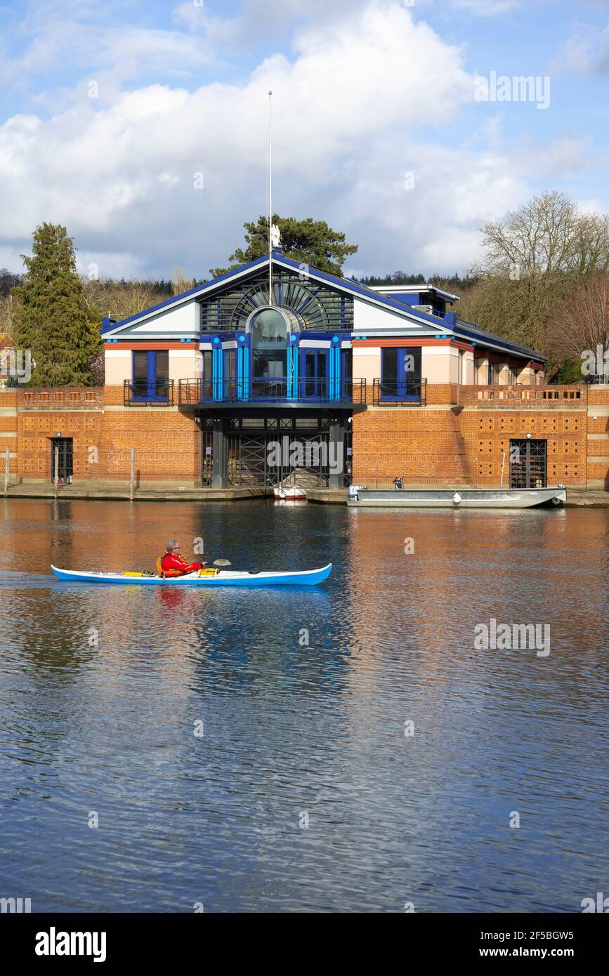 Canoeist paddles past the Henley Royal Regatta headquarters on the the River Thames at Henley-on-Thames, Berkshire, England, UK Stock Photo