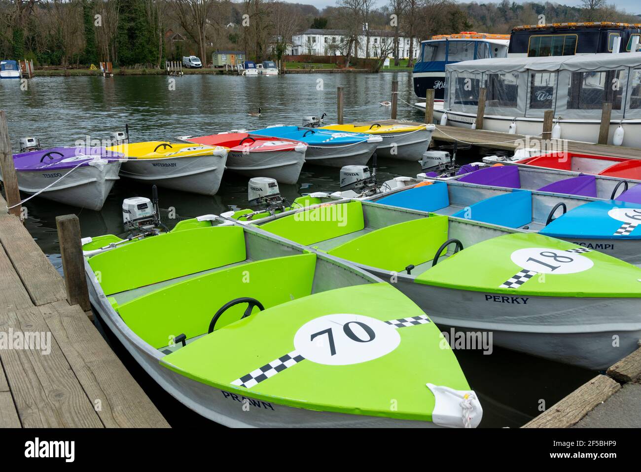 Colourful hire boats waiting for customers when lockdown ends - Henley-on-Thames, Oxfordshire, England, UK Stock Photo
