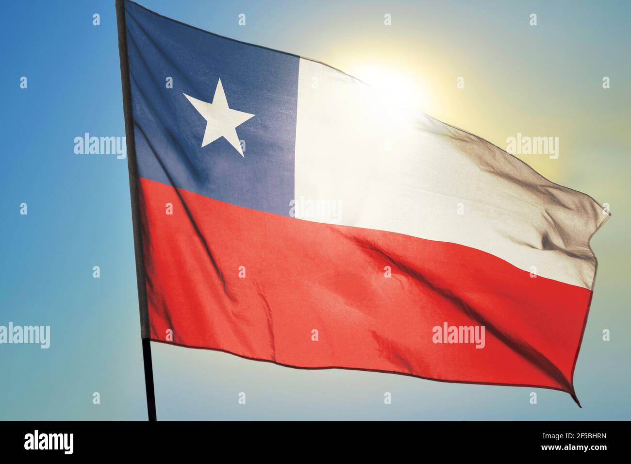 Chile flag waving on the wind in front of sun Stock Photo