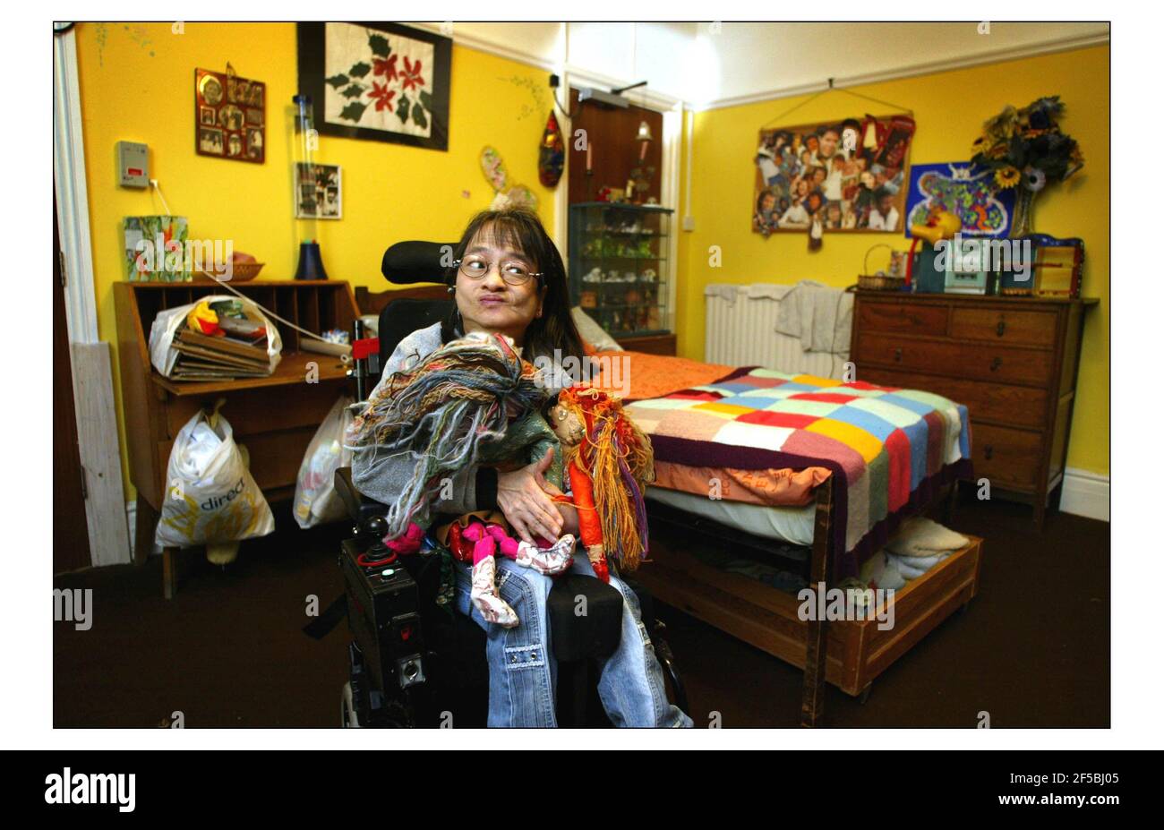 CHRISTMAS APPEAL..........Ockenden International supports Kilmore House in Camberly, Surrey, where some of the 1975 vietnam refugees with learning difficulties live.  Binh Nguyen Thi Lam with the dolls she has made in her room.pic David Sandison 10/12/2003 Stock Photo