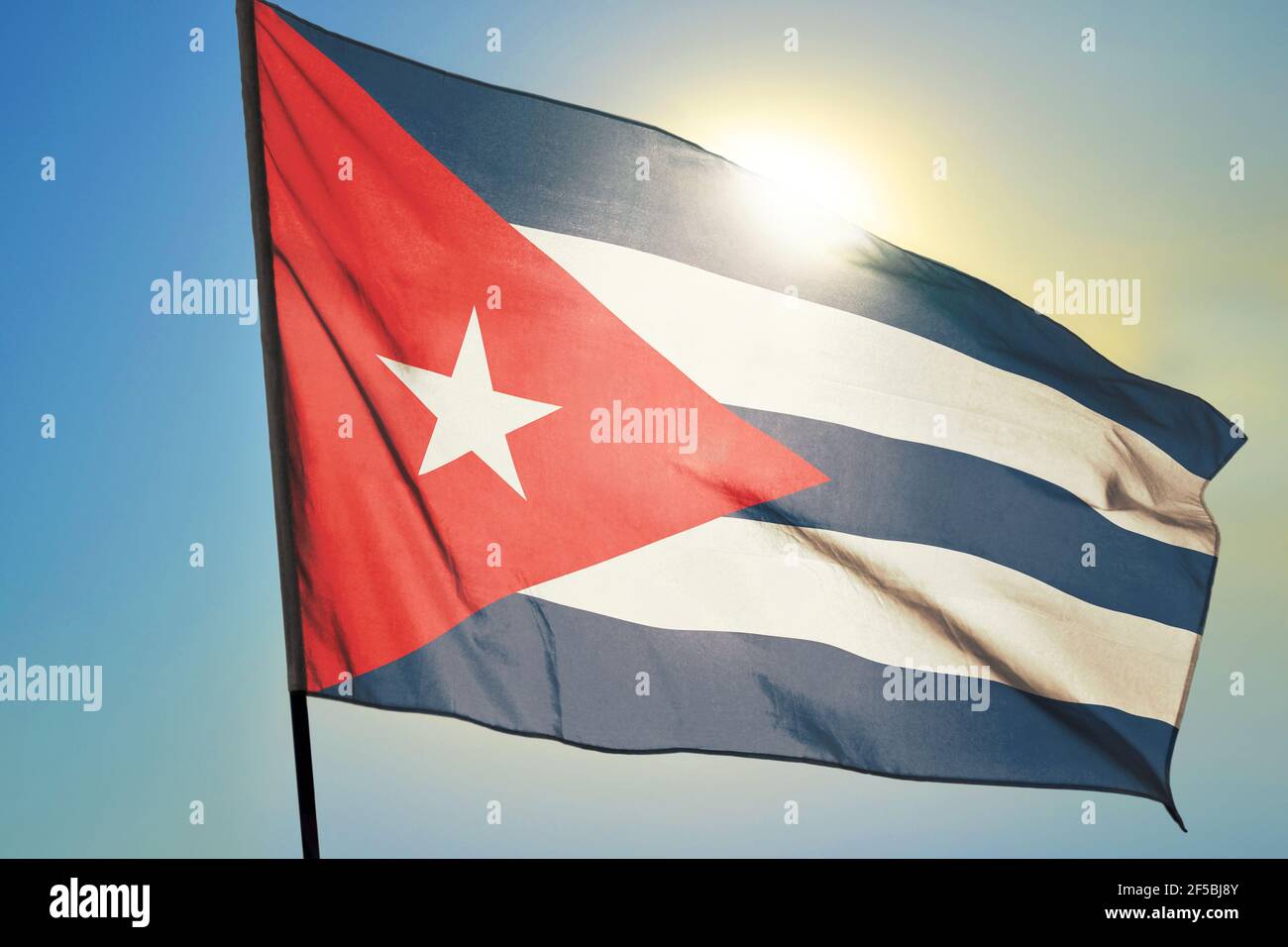 Cuba flag waving on the wind in front of sun Stock Photo