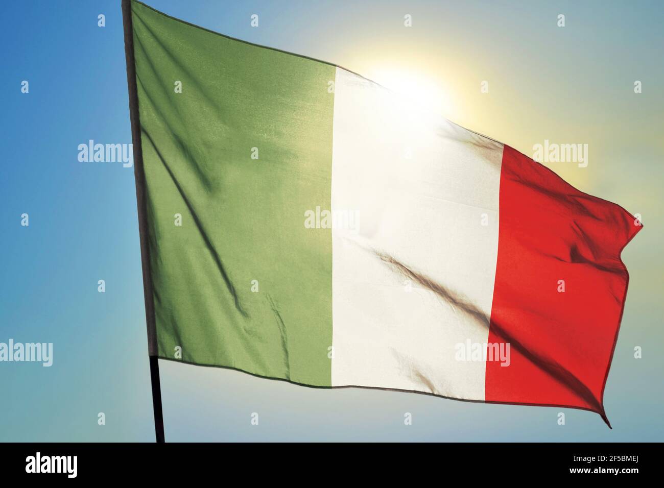 Italy flag waving on the wind in front of sun Stock Photo