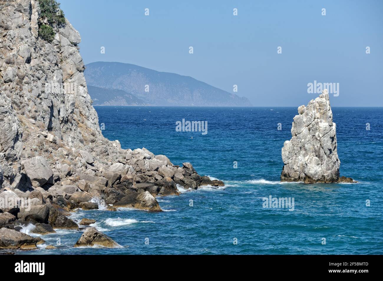 = Rocks of Cape Ai-Todor and the Blue Black Sea =  View of 'Limen-Burun', the eastern spur of Cape Ai-Todor and a small rocky island called 'Parus' (S Stock Photo