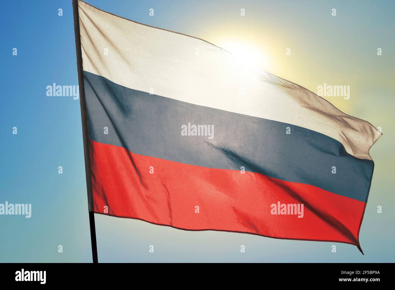 Russia flag waving on the wind in front of sun Stock Photo
