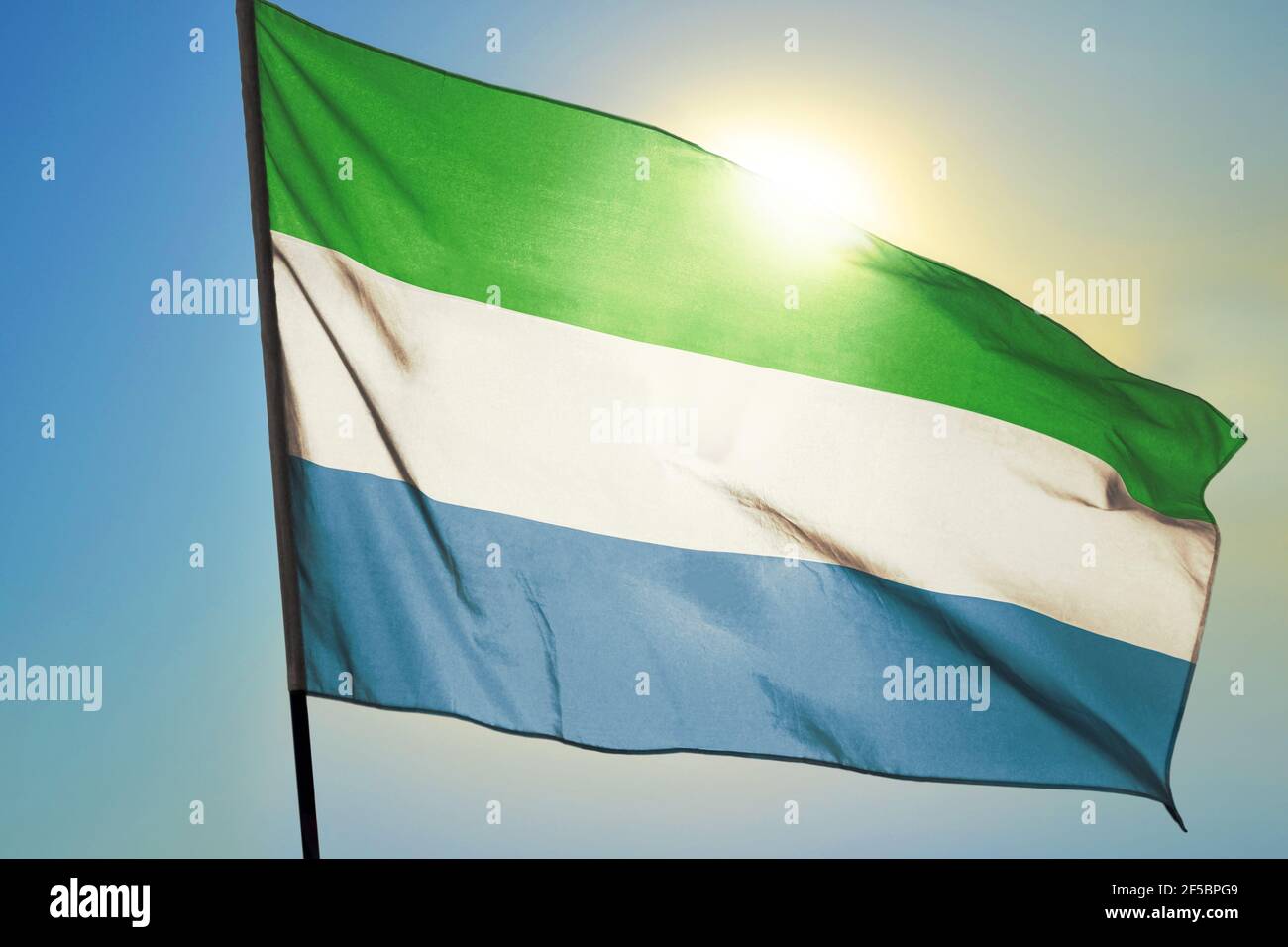 Sierra Leone flag waving on the wind in front of sun Stock Photo - Alamy