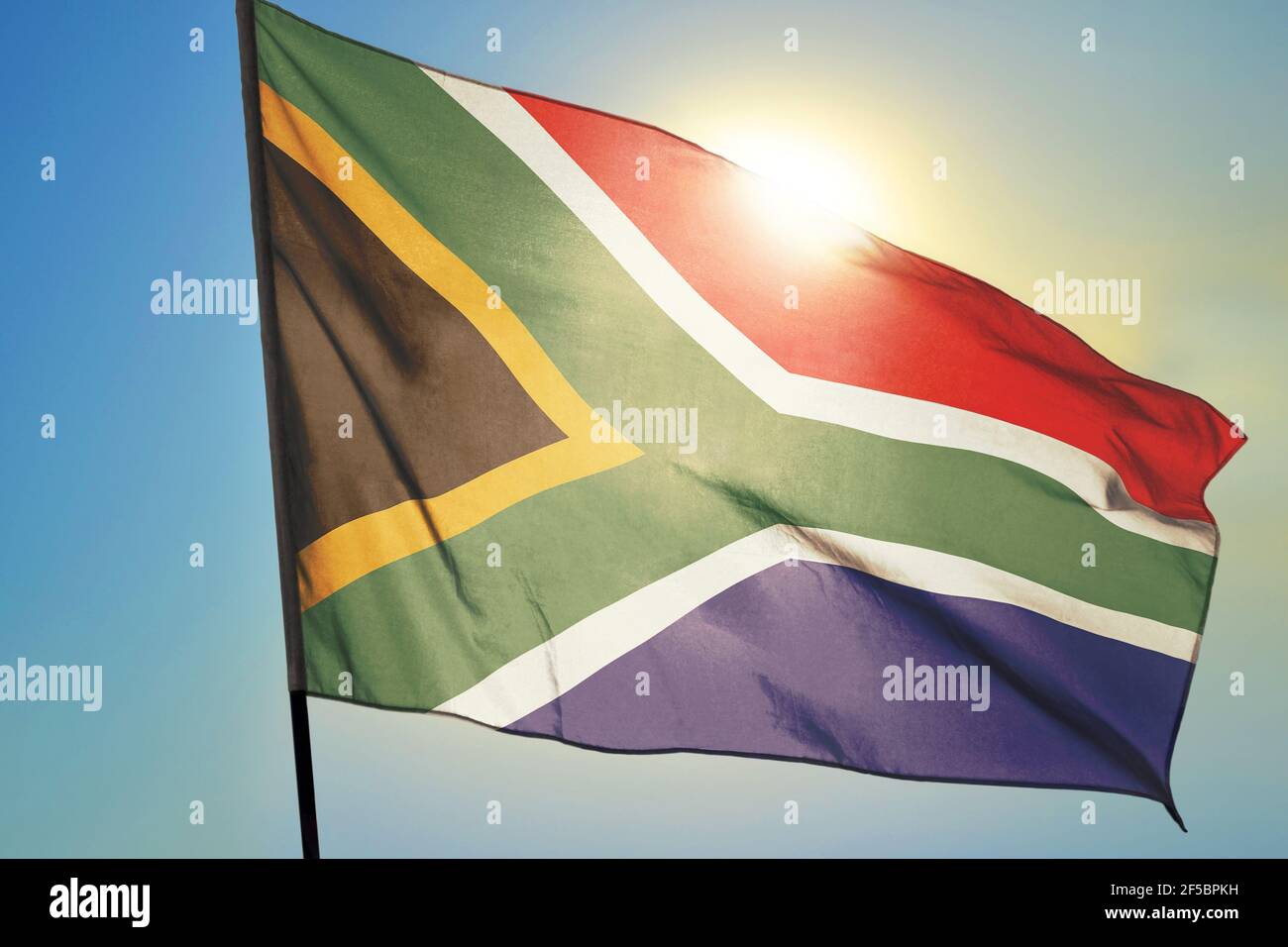 South Africa flag waving on the wind in front of sun Stock Photo
