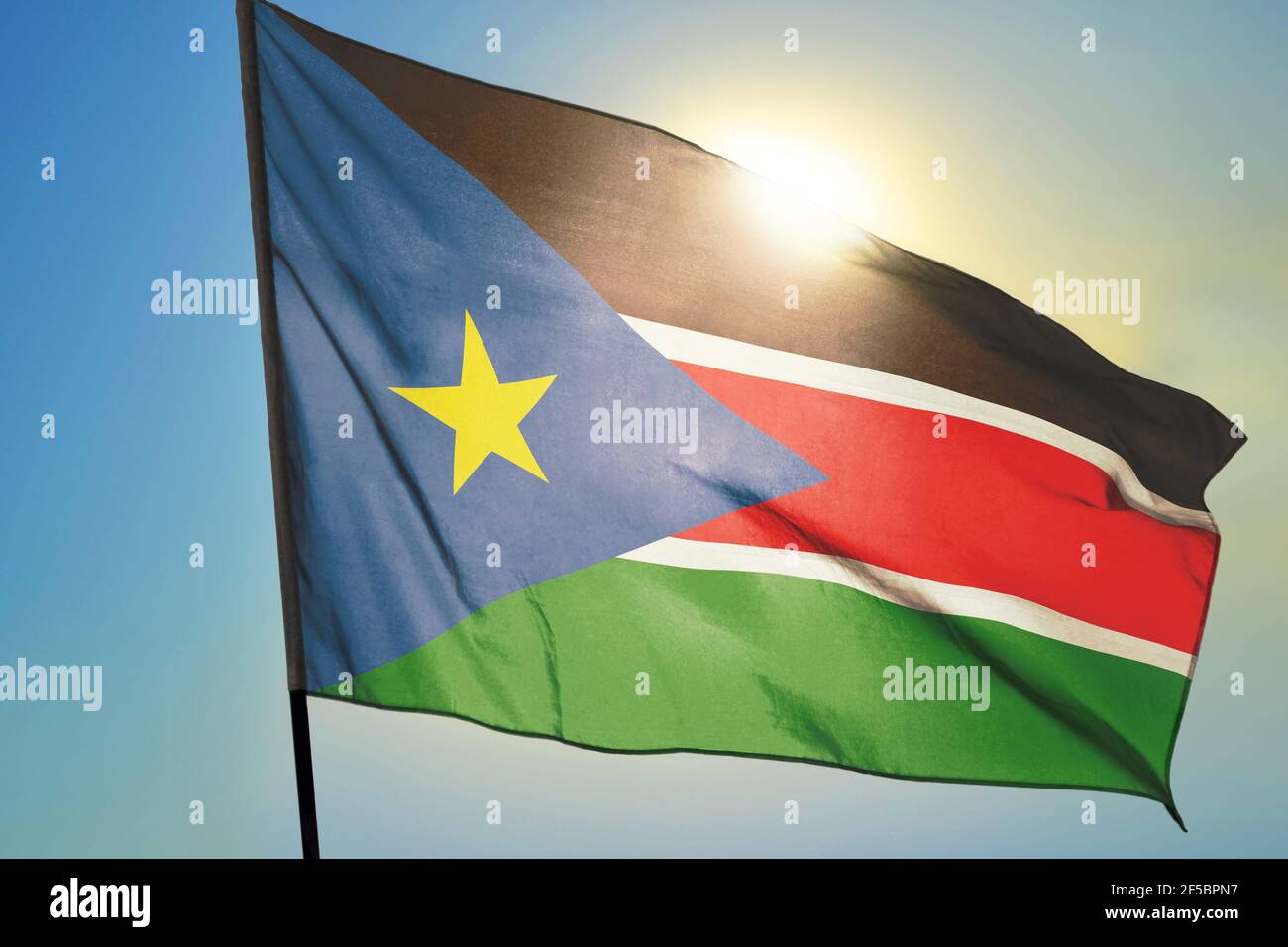 South Sudan flag waving on the wind in front of sun Stock Photo - Alamy