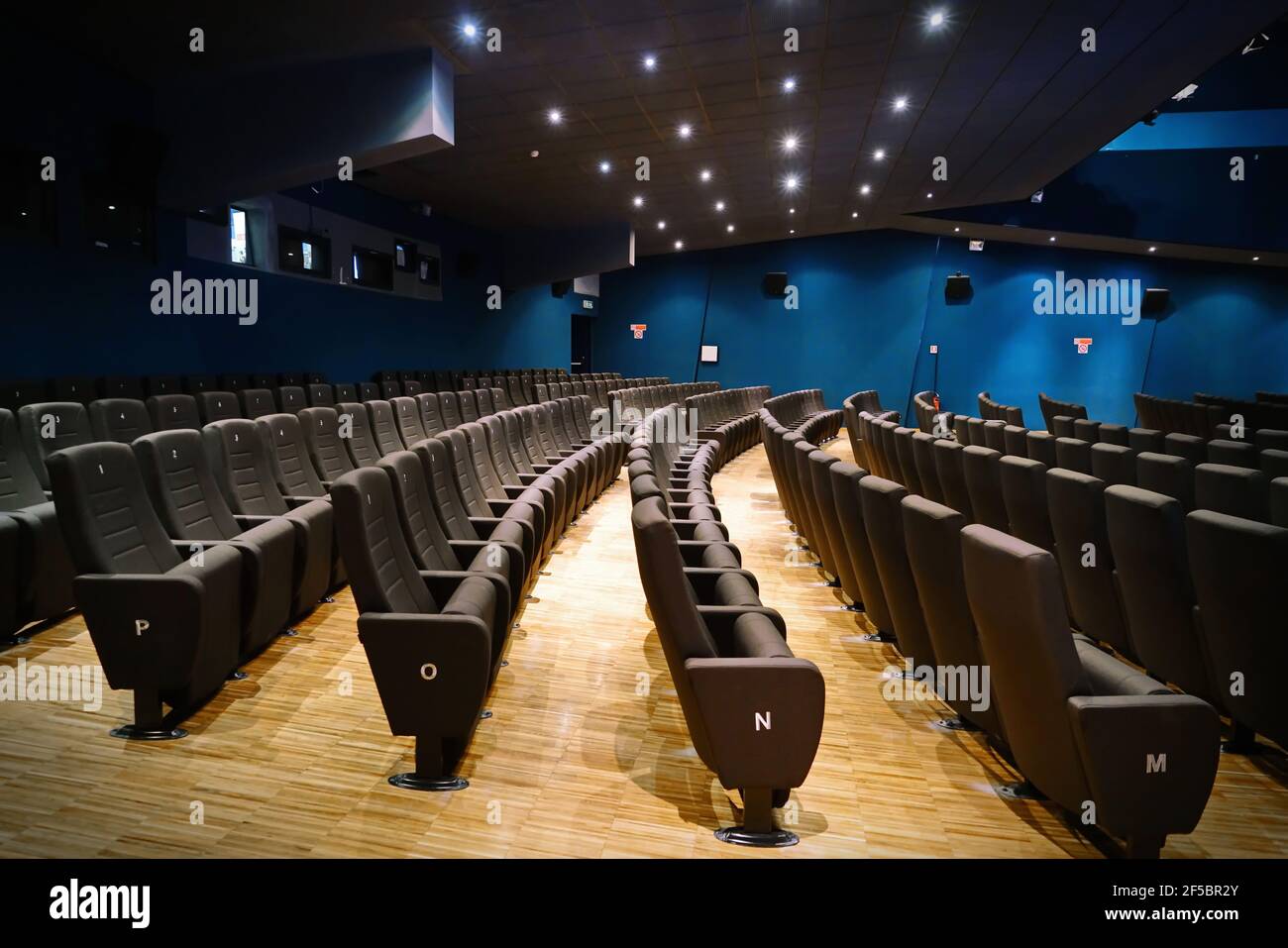 Cinema closed due to Coronavirus. Movie theater closure under COVID-19 global pandemic. Empty velvet seats in theater, cinema. Stock Photo