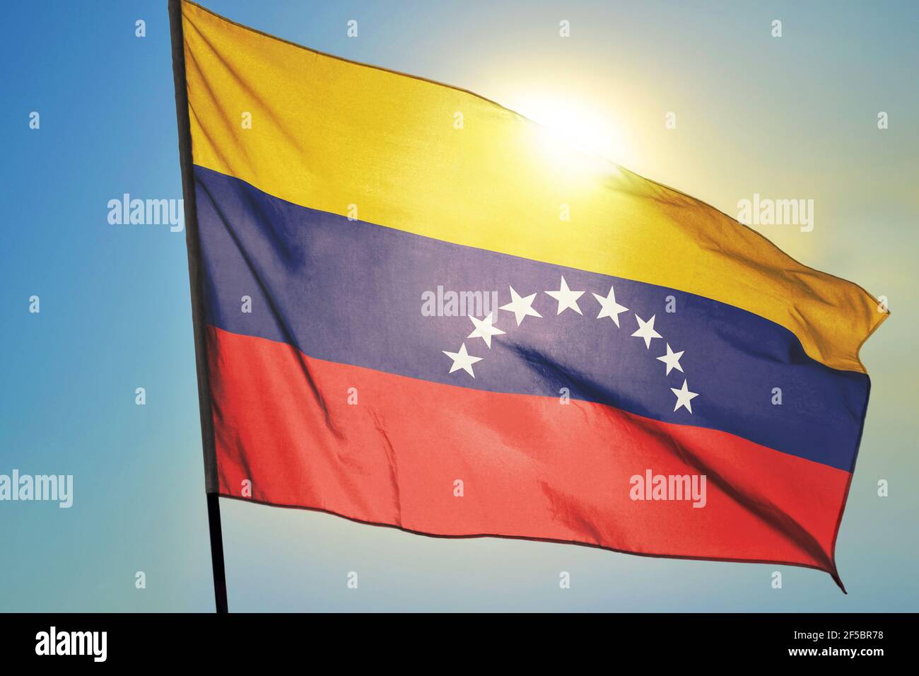 Venezuela flag waving on the wind in front of sun Stock Photo