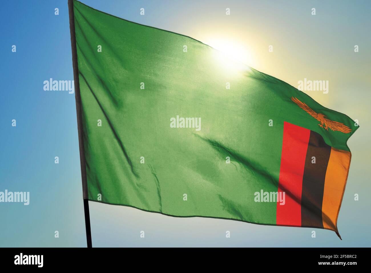 Zambia flag waving on the wind in front of sun Stock Photo - Alamy