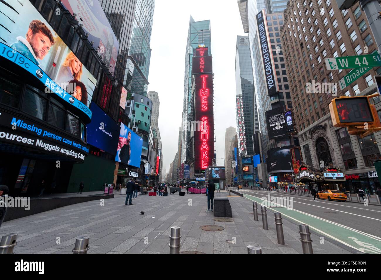 view of the neon sign at 1 Times Square from across Times Square on a foggy day during the coronavirus or covid-19 pandemic, mostly empty Stock Photo