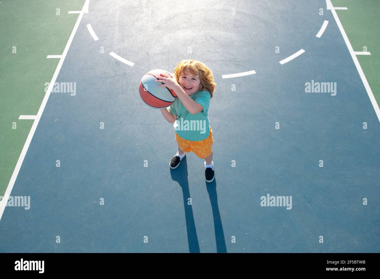 Little boy playing basketball. Child sport activity. Kids basketball