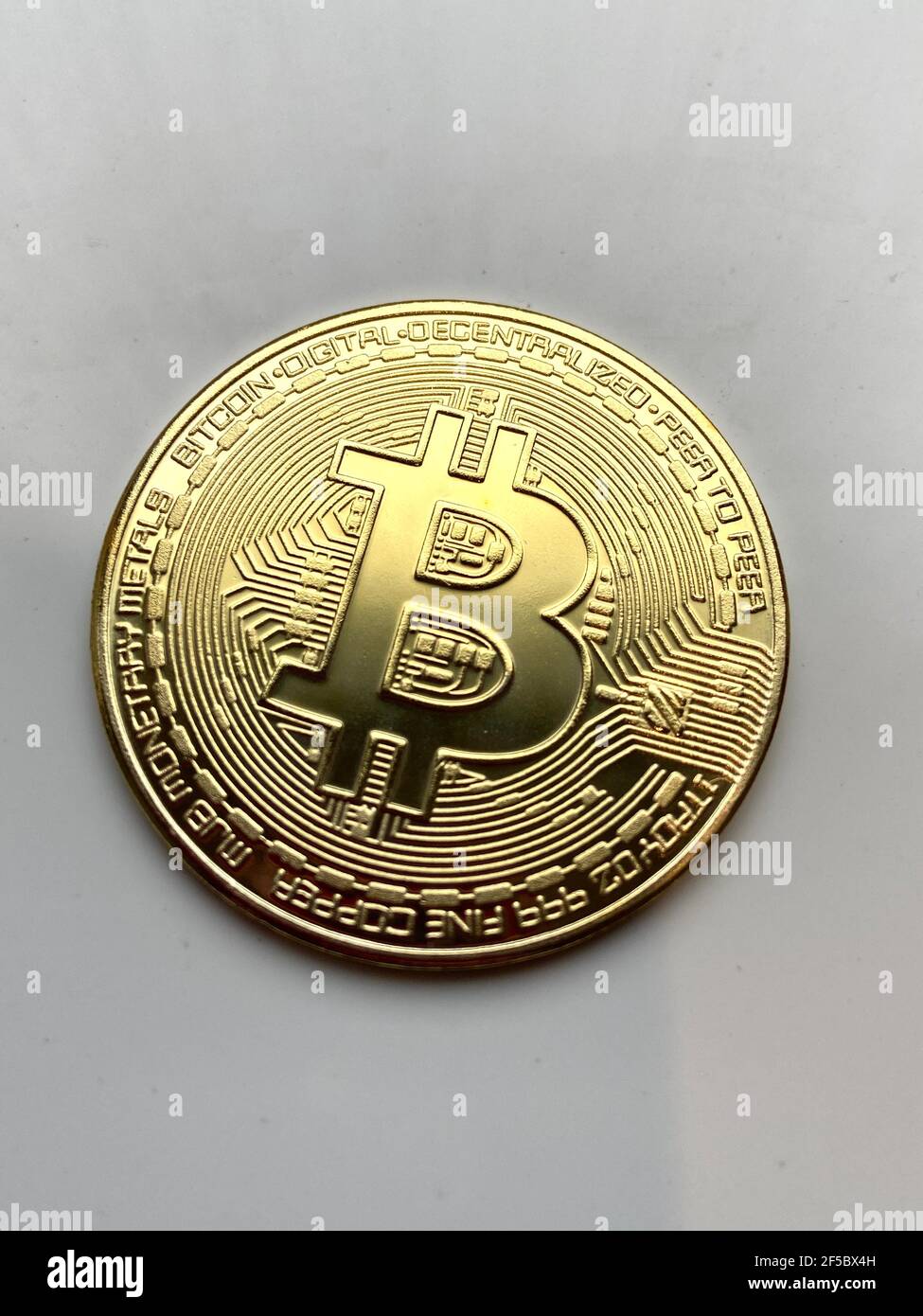 London, UK - 04/04/2021: Golden bitcoin on silver metal background, bitcoin  is most popular crypto currency coin with copy space behind bitcoin Stock  Photo - Alamy