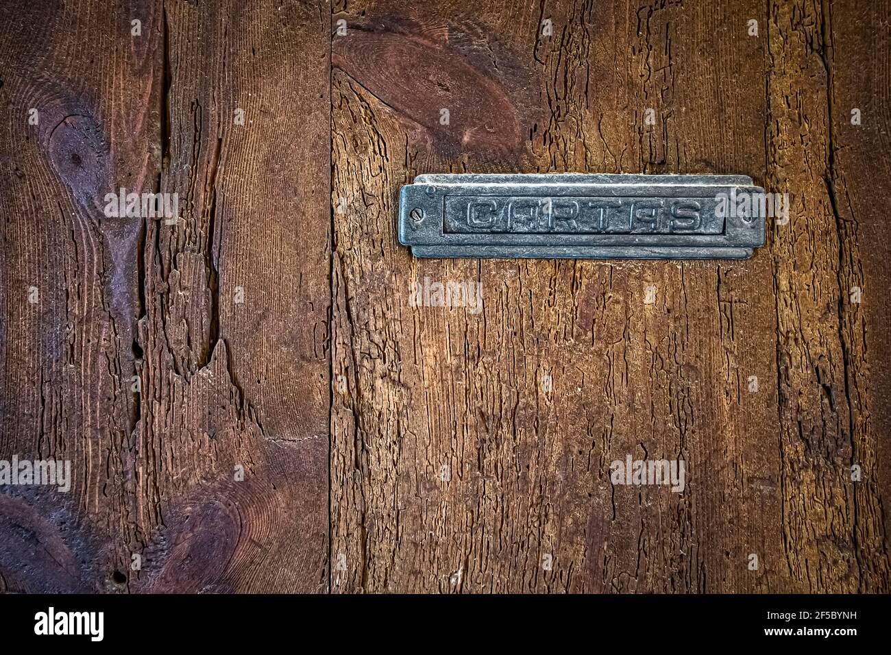 texture of an old wooden door, rural texture with a recessed metal